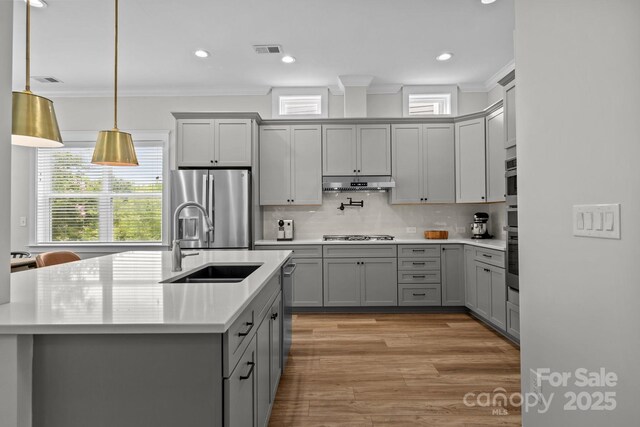 11329 Fullerton Place Dr NW, Huntersville, NC 28078 - kitchen featuring gray cabinets, a sink, stainless steel appliances, crown molding, and under cabinet range hood