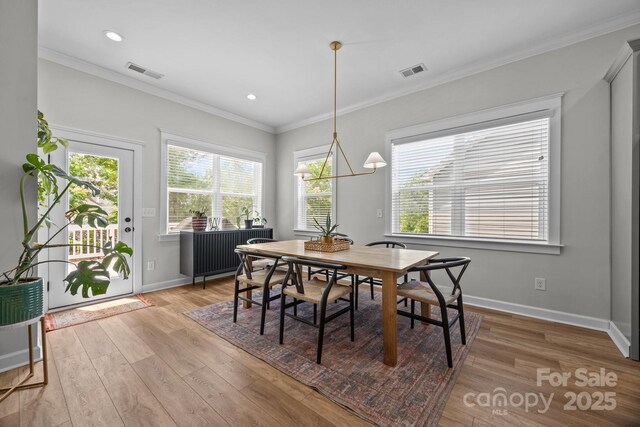 11329 Fullerton Place Dr NW, Huntersville, NC 28078 - dining area with light wood finished floors, plenty of natural light, baseboards, crown molding, and recessed lighting