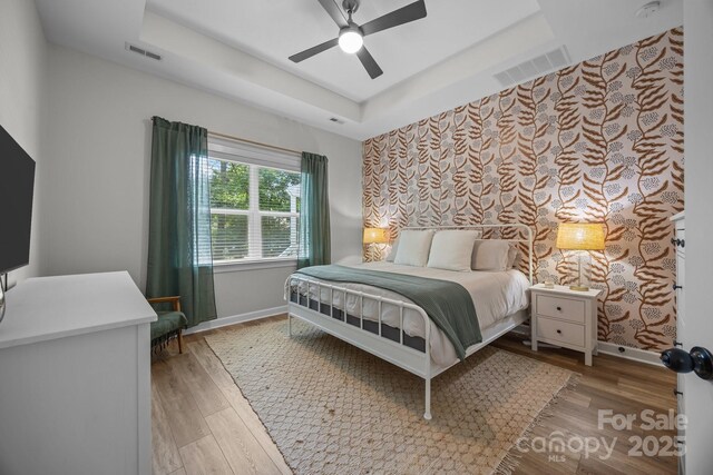 11329 Fullerton Place Dr NW, Huntersville, NC 28078 - bedroom with wood finished floors, baseboards, a raised ceiling, and ceiling fan