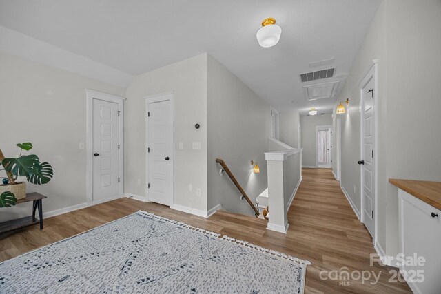 11329 Fullerton Place Dr NW, Huntersville, NC 28078 - hall featuring an upstairs landing, wood finished floors, and attic access