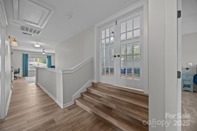 11329 Fullerton Place Dr NW, Huntersville, NC 28078 - hallway featuring french doors, wood finished floors, and attic access
