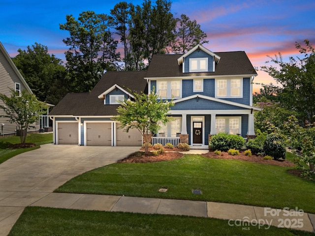 11329 Fullerton Place Dr NW, Huntersville, NC 28078 - view of front of property featuring a porch, concrete driveway, a lawn, and a garage