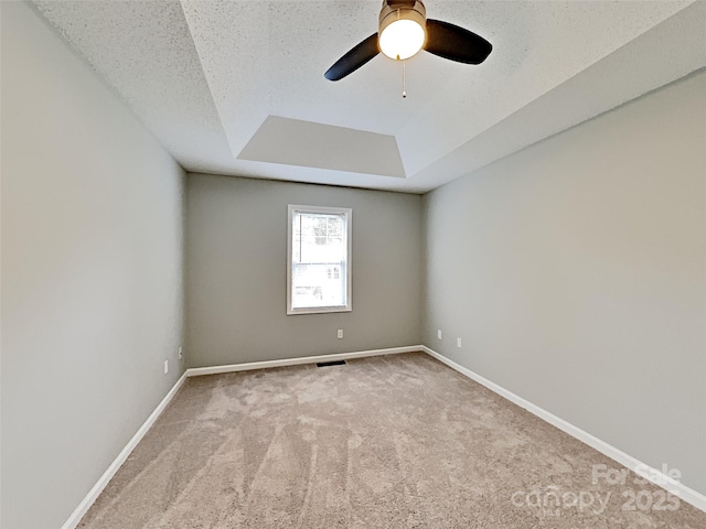 120 Todd Dr NW, Concord, NC 28025 - carpeted spare room with a tray ceiling, a ceiling fan, and baseboards