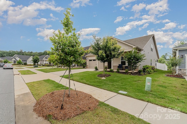 9274 Dunwich Dr, Gastonia, NC 28056 - view of front of house featuring board and batten siding, concrete driveway, an attached garage, and a front lawn