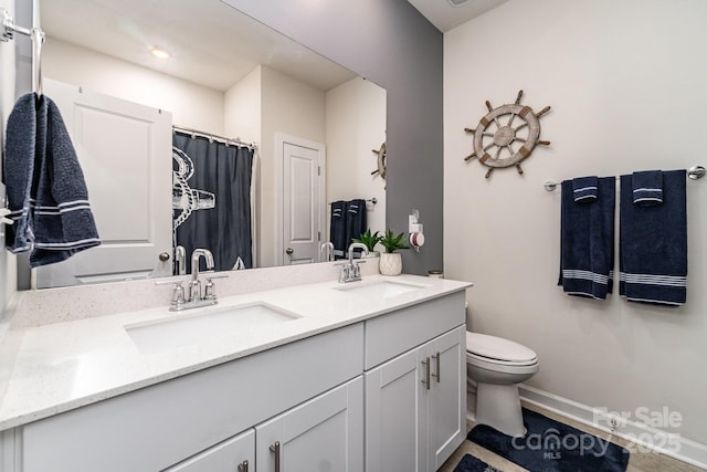 9274 Dunwich Dr, Gastonia, NC 28056 - bathroom with double vanity, toilet, baseboards, and a shower with shower curtain