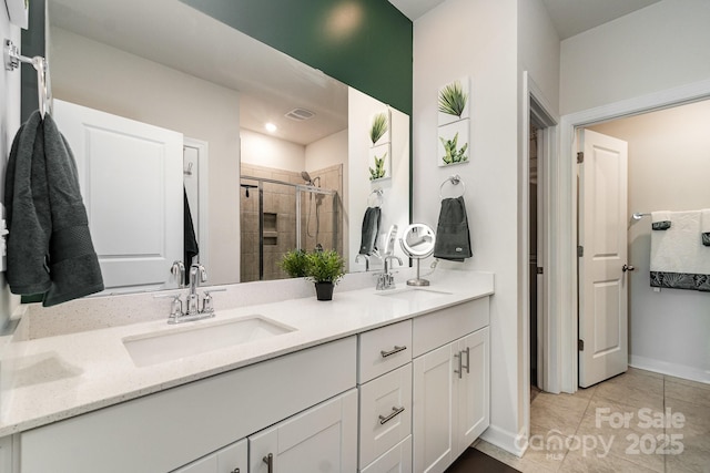 9274 Dunwich Dr, Gastonia, NC 28056 - bathroom featuring double vanity, a stall shower, baseboards, and tile patterned floors
