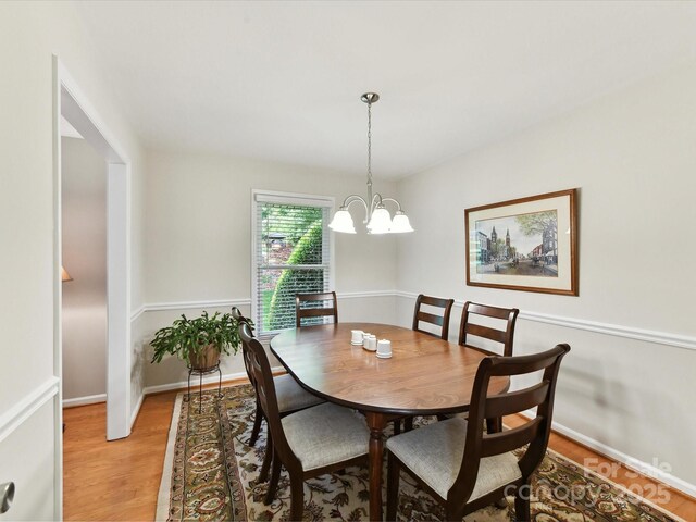 13617 Lake Bluff Dr, Matthews, NC 28105 - dining room featuring light wood-style floors, a chandelier, and baseboards