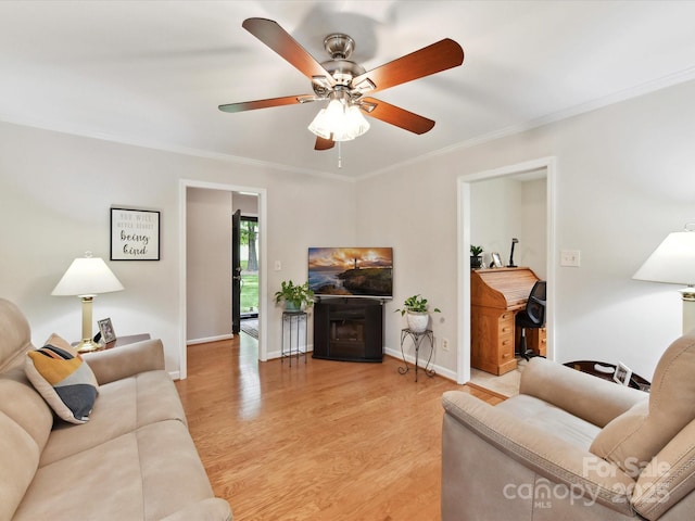 13617 Lake Bluff Dr, Matthews, NC 28105 - living area featuring ornamental molding, light wood finished floors, ceiling fan, baseboards, and a fireplace