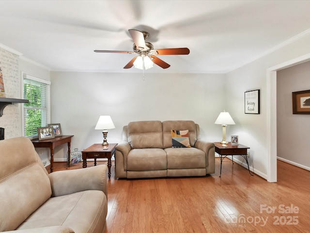 13617 Lake Bluff Dr, Matthews, NC 28105 - living room featuring ceiling fan, light wood-style floors, ornamental molding, baseboards, and a fireplace