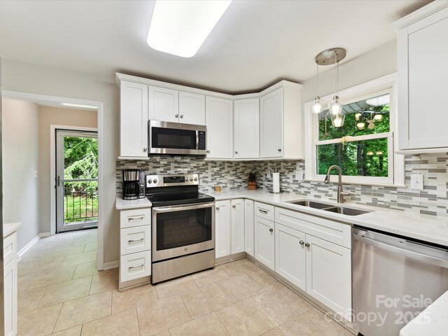 13617 Lake Bluff Dr, Matthews, NC 28105 - kitchen featuring stainless steel appliances, a sink, light countertops, backsplash, and white cabinets