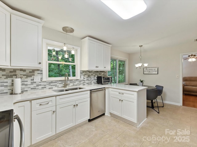 13617 Lake Bluff Dr, Matthews, NC 28105 - kitchen featuring dishwasher, a sink, backsplash, range, and a peninsula