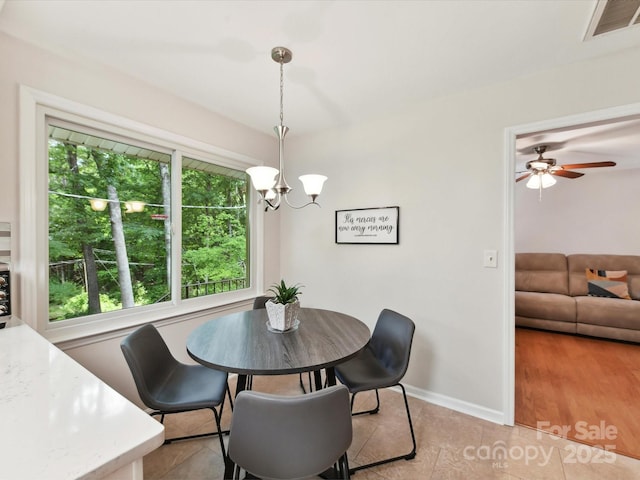 13617 Lake Bluff Dr, Matthews, NC 28105 - dining space featuring a chandelier, light tile patterned floors, ceiling fan, and baseboards