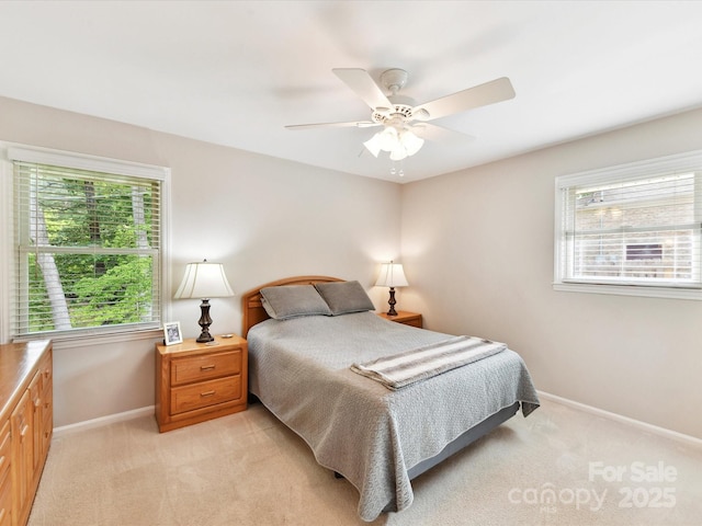 13617 Lake Bluff Dr, Matthews, NC 28105 - bedroom with baseboards, light carpet, multiple windows, and ceiling fan