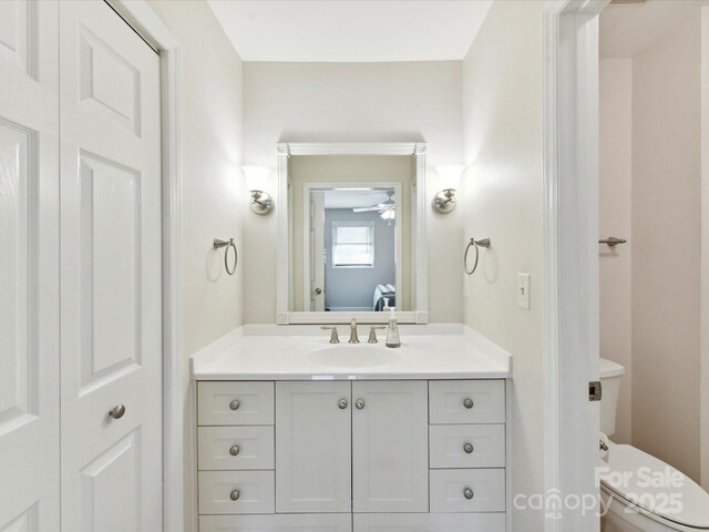 13617 Lake Bluff Dr, Matthews, NC 28105 - bathroom with vanity, toilet, and ceiling fan