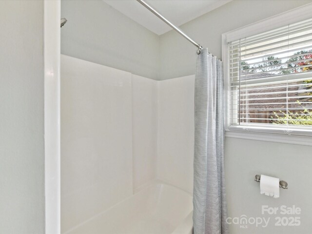 13617 Lake Bluff Dr, Matthews, NC 28105 - bathroom featuring healthy amount of natural light and shower / bath combination with curtain
