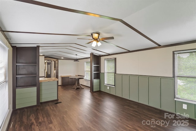 1712 NC-126 Hwy, Morganton, NC 28655 - unfurnished living room with vaulted ceiling, a ceiling fan, wainscoting, dark wood-style flooring, and a decorative wall