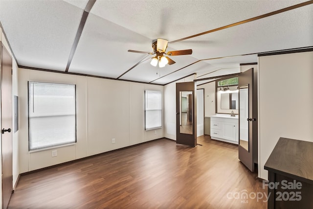 1712 NC-126 Hwy, Morganton, NC 28655 - unfurnished bedroom featuring wood finished floors, lofted ceiling, multiple windows, french doors, and a textured ceiling