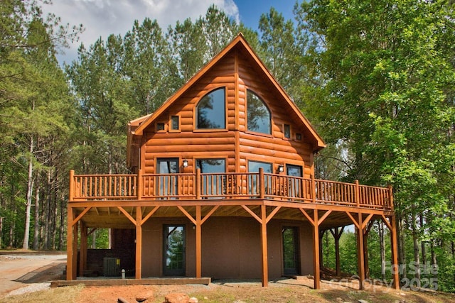 317 Knightsbridge Cir, Union Mills, NC 28167 - back of house featuring a wooden deck, central AC unit, and faux log siding