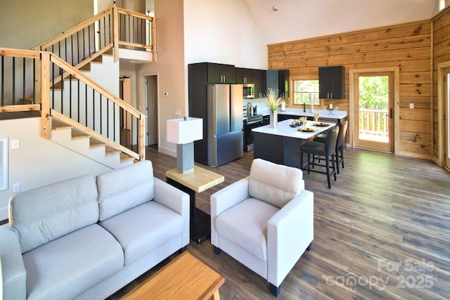 317 Knightsbridge Cir, Union Mills, NC 28167 - living room with high vaulted ceiling, stairway, wooden walls, and dark wood-style flooring