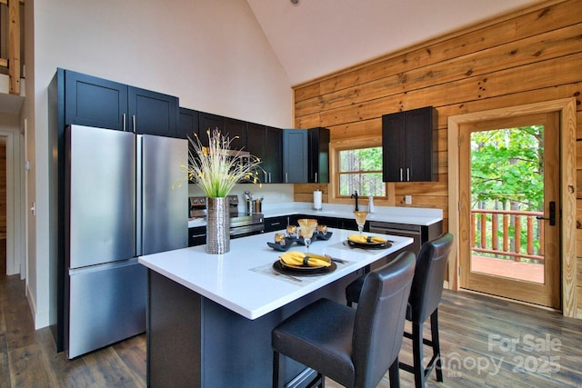 317 Knightsbridge Cir, Union Mills, NC 28167 - kitchen with stainless steel appliances, light countertops, dark wood-type flooring, wooden walls, and a breakfast bar