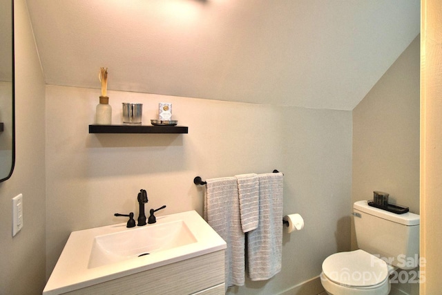 317 Knightsbridge Cir, Union Mills, NC 28167 - bathroom with lofted ceiling, toilet, vanity, and baseboards