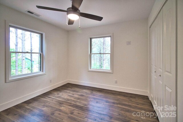 317 Knightsbridge Cir, Union Mills, NC 28167 - unfurnished bedroom with a closet, baseboards, dark wood-style flooring, and ceiling fan