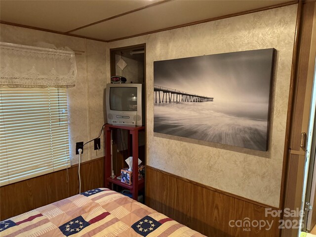 160/162 Arrowood Trl Unit F28/F29, Mount Gilead, NC 27306 - bedroom featuring wood walls and ornamental molding