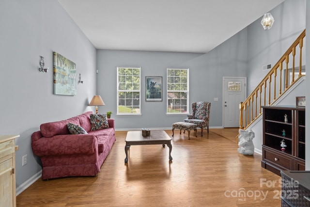 7212 Morsey Ct, Charlotte, NC 28269 - living room featuring stairs, wood finished floors, and baseboards