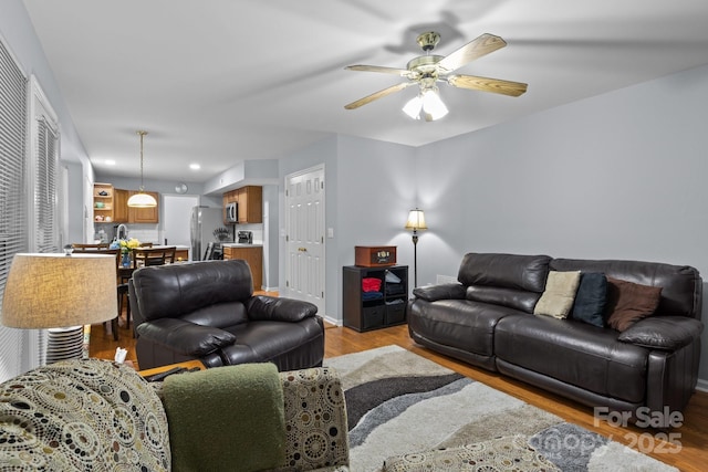 7212 Morsey Ct, Charlotte, NC 28269 - living area with light wood-type flooring, ceiling fan, and baseboards