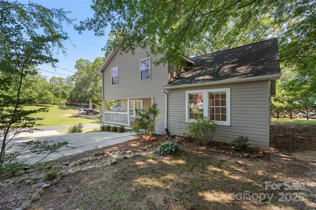 202 Glenn Ave, Kannapolis, NC 28081 - back of house featuring a porch, a shingled roof, and a yard