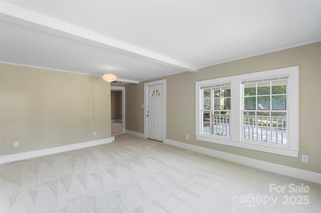202 Glenn Ave, Kannapolis, NC 28081 - spare room featuring light colored carpet, crown molding, and beam ceiling