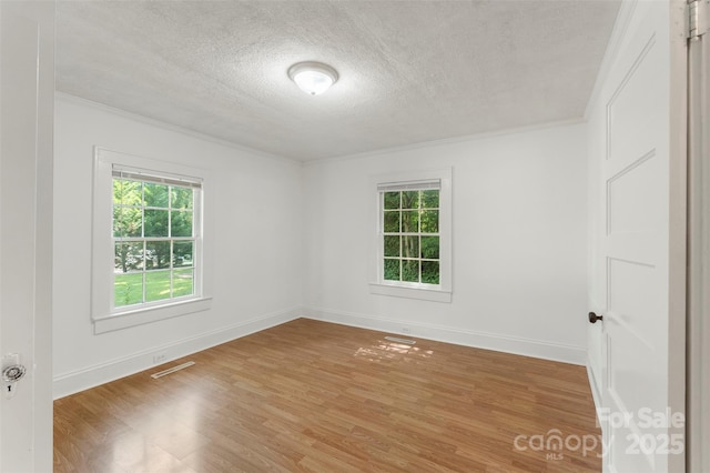 202 Glenn Ave, Kannapolis, NC 28081 - empty room with a textured ceiling, healthy amount of natural light, light wood-style floors, and crown molding