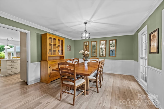 2917 Rustic Ln, Charlotte, NC 28210 - dining area with light wood finished floors, wainscoting, crown molding, and a chandelier