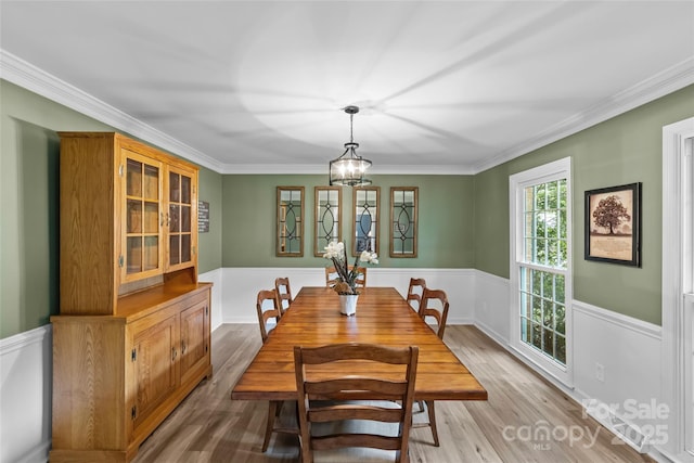 2917 Rustic Ln, Charlotte, NC 28210 - dining area featuring wainscoting, light wood-style floors, ornamental molding, and a chandelier