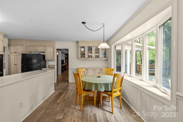 2917 Rustic Ln, Charlotte, NC 28210 - dining room featuring healthy amount of natural light, light wood-style floors, and ornamental molding