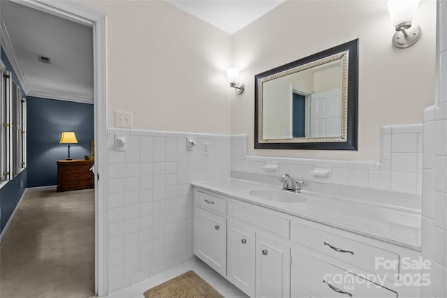 2917 Rustic Ln, Charlotte, NC 28210 - bathroom with vanity, wainscoting, tile walls, and ornamental molding