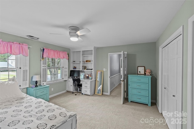 2917 Rustic Ln, Charlotte, NC 28210 - bedroom with an office area, light carpet, a closet, and a ceiling fan