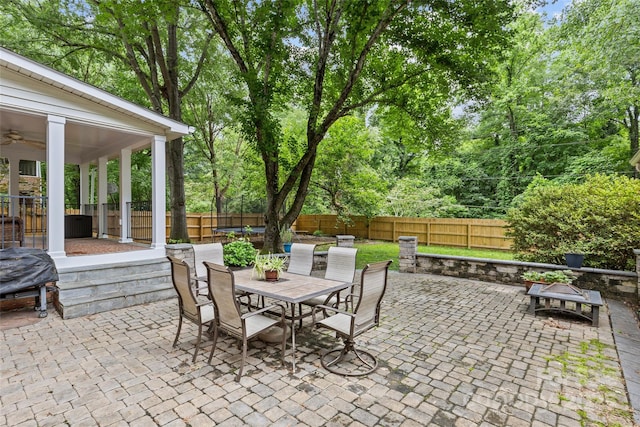2917 Rustic Ln, Charlotte, NC 28210 - fenced backyard with outdoor dining space, a patio, a ceiling fan, and view of scattered trees