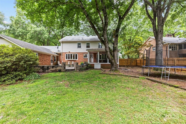 2917 Rustic Ln, Charlotte, NC 28210 - rear view of house with a trampoline, a fenced backyard, and brick siding