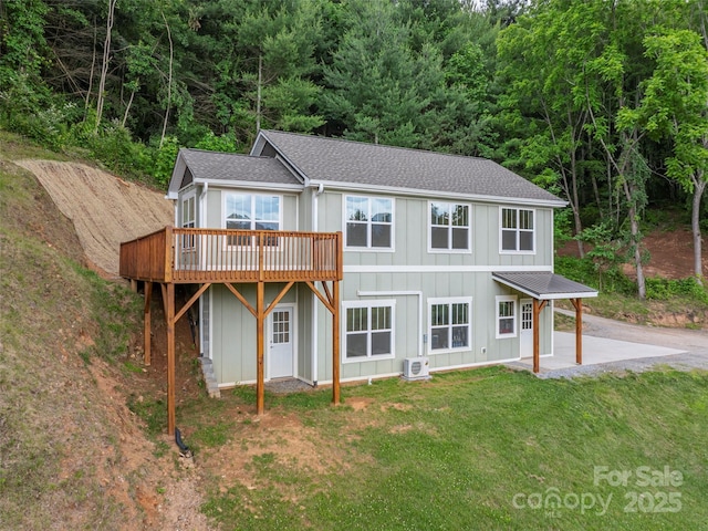 558 Liner Cove Rd, Waynesville, NC 28786 - rear view of property with board and batten siding, a shingled roof, a lawn, a wooden deck, and a patio area