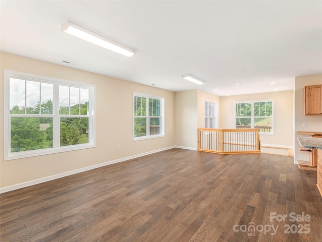 558 Liner Cove Rd, Waynesville, NC 28786 - unfurnished living room featuring dark wood-style flooring and healthy amount of natural light