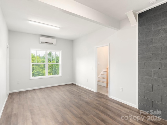 558 Liner Cove Rd, Waynesville, NC 28786 - spare room featuring a wall unit AC, dark wood-style flooring, and stairway