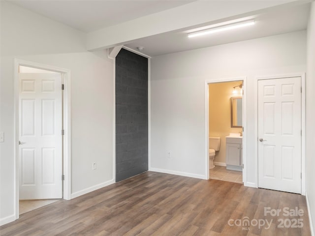 558 Liner Cove Rd, Waynesville, NC 28786 - unfurnished bedroom featuring wood finished floors and ensuite bathroom