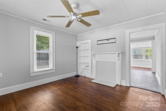 2519 2nd Ave SW, Hickory, NC 28602 - unfurnished living room featuring ornamental molding, a ceiling fan, healthy amount of natural light, and wood finished floors