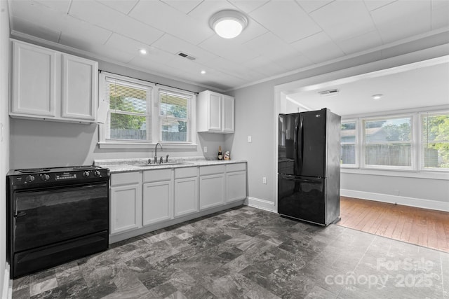 2519 2nd Ave SW, Hickory, NC 28602 - kitchen with black appliances, white cabinetry, and ornamental molding
