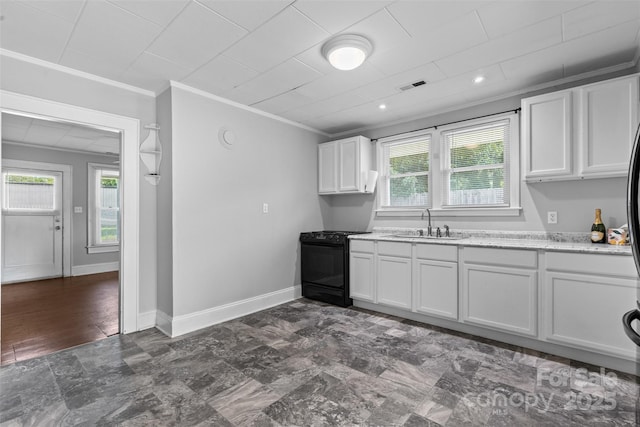 2519 2nd Ave SW, Hickory, NC 28602 - kitchen featuring black range oven, ornamental molding, and white cabinets
