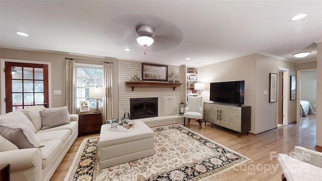 1695 Arden Dr, Lincolnton, NC 28092 - living area with light wood-type flooring, ornamental molding, a brick fireplace, ceiling fan, and recessed lighting