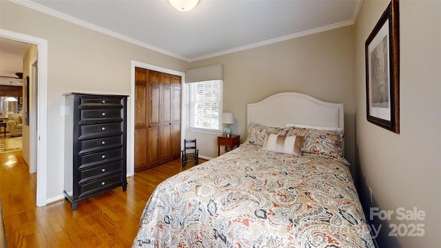 1695 Arden Dr, Lincolnton, NC 28092 - bedroom with wood finished floors, ornamental molding, and a closet