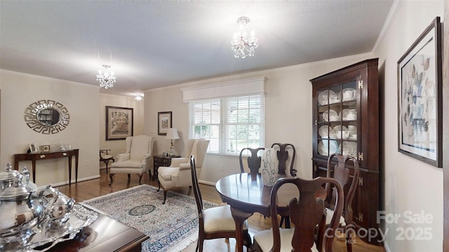 1695 Arden Dr, Lincolnton, NC 28092 - dining area featuring a chandelier, ornamental molding, and wood finished floors