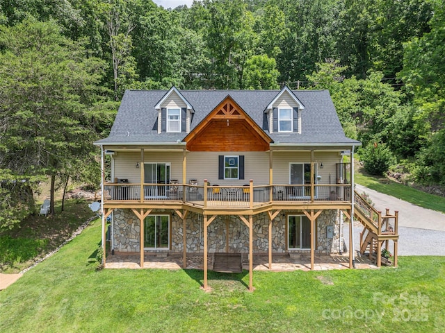 80 Feather Ln, Waynesville, NC 28786 - rear view of house with stone siding, a deck, a yard, a patio area, and a wooded view